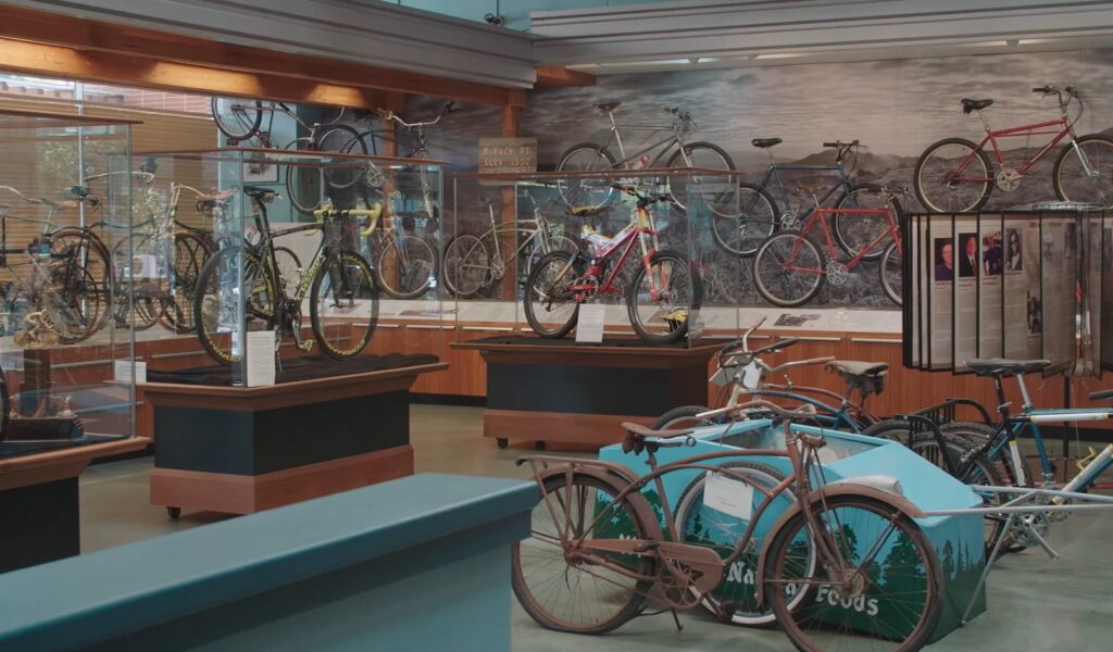 Interior view of a bicycle museum displaying a variety of vintage bikes