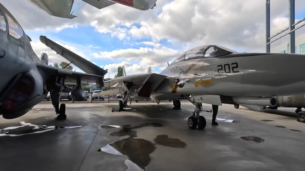 Military jets on display under a cloudy sky at an outdoor museum